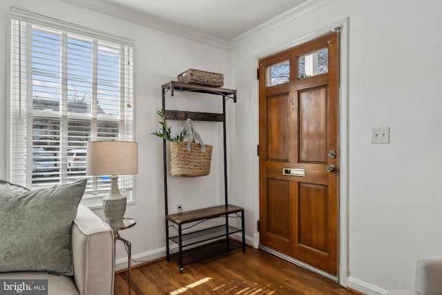 entryway featuring ornamental molding, dark wood-type flooring, plenty of natural light, and baseboards