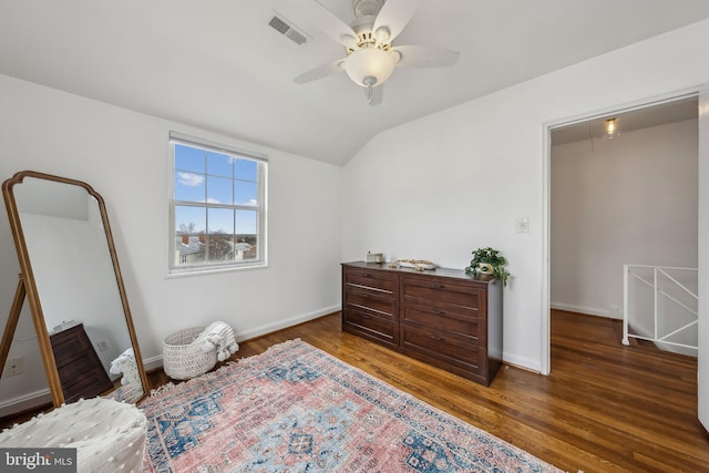 bedroom with attic access, baseboards, visible vents, wood finished floors, and vaulted ceiling