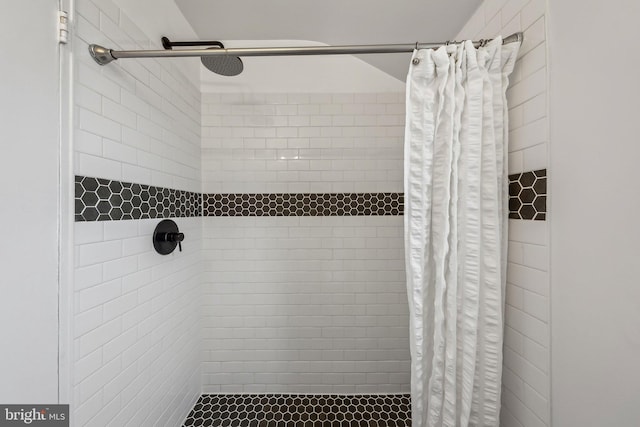 full bathroom with tiled shower