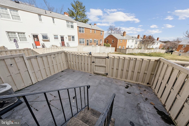 view of patio featuring a fenced backyard, a residential view, and a gate