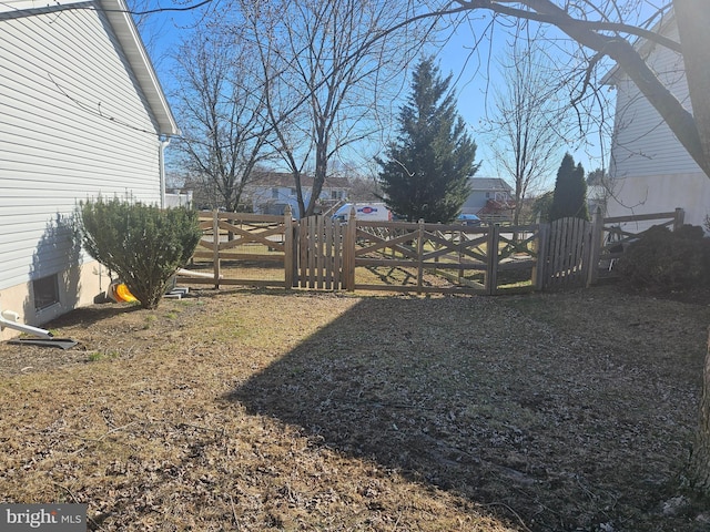 view of yard with a gate and fence