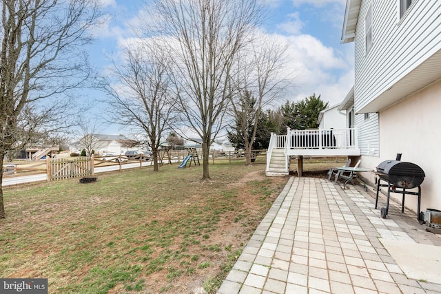 view of yard with fence private yard, a patio, a playground, and a wooden deck