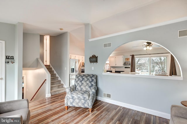 living area featuring wood finished floors, visible vents, and baseboards