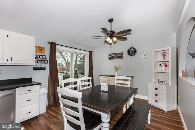 dining area with dark wood-style floors, ceiling fan, and baseboards