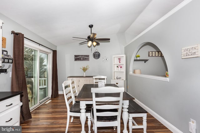 dining area with dark wood-style floors, lofted ceiling, ceiling fan, and baseboards