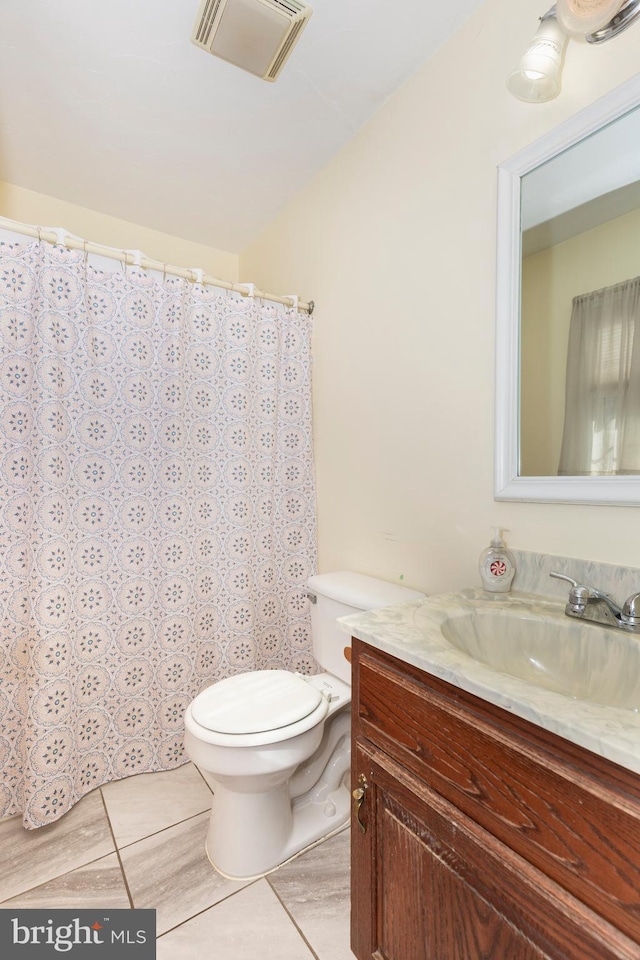 bathroom with visible vents, a shower with shower curtain, toilet, vanity, and tile patterned flooring