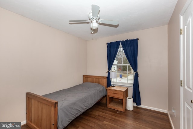 bedroom with ceiling fan, baseboards, and dark wood finished floors