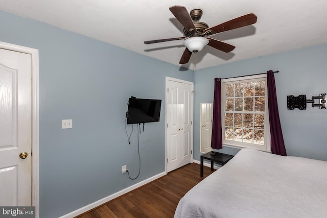 bedroom featuring ceiling fan, baseboards, and wood finished floors