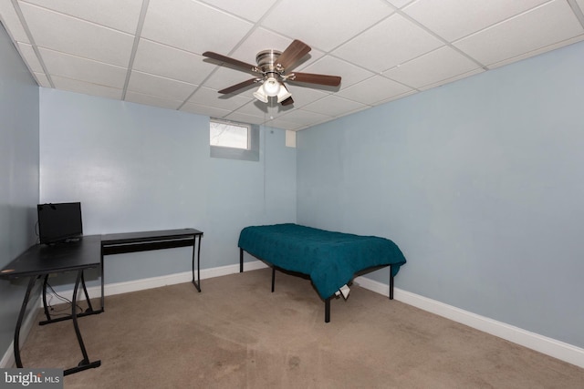 interior space featuring ceiling fan, carpet floors, a paneled ceiling, and baseboards