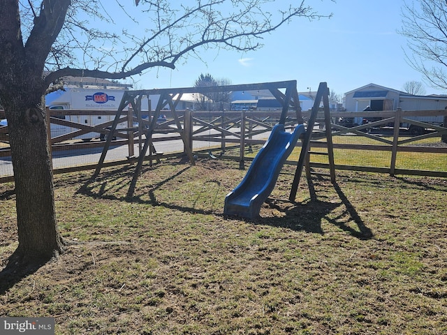 view of playground with a lawn