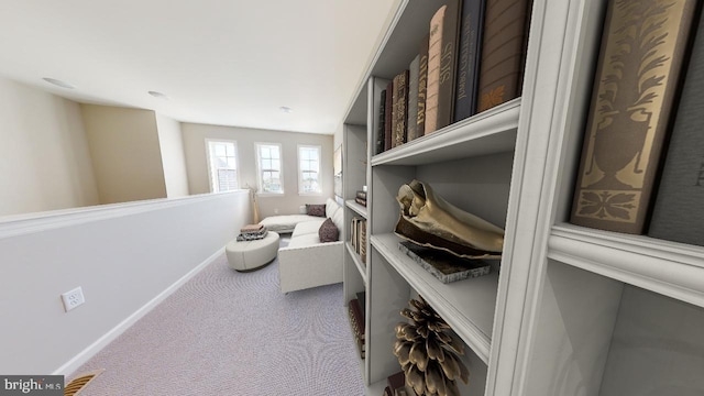 sitting room featuring carpet floors and baseboards