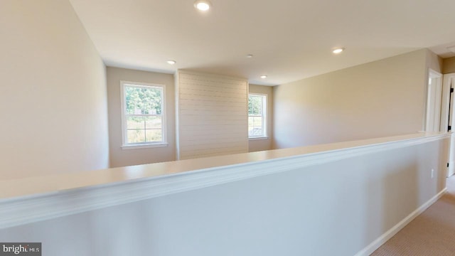 corridor featuring carpet, baseboards, and recessed lighting