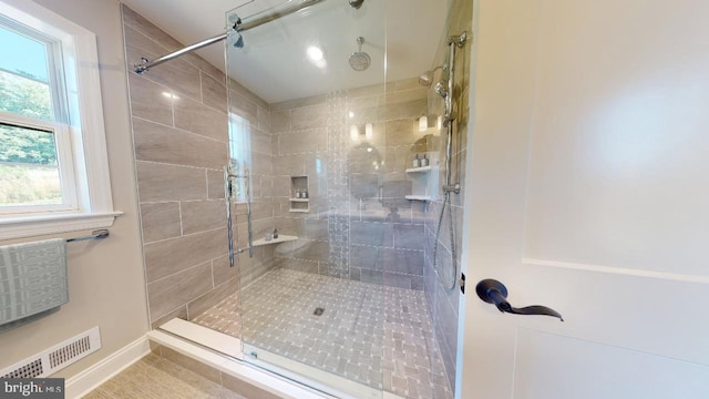 full bathroom featuring visible vents and a tile shower