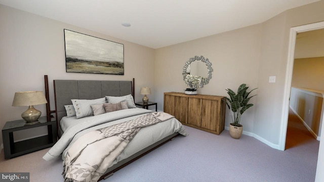 bedroom featuring light carpet and baseboards