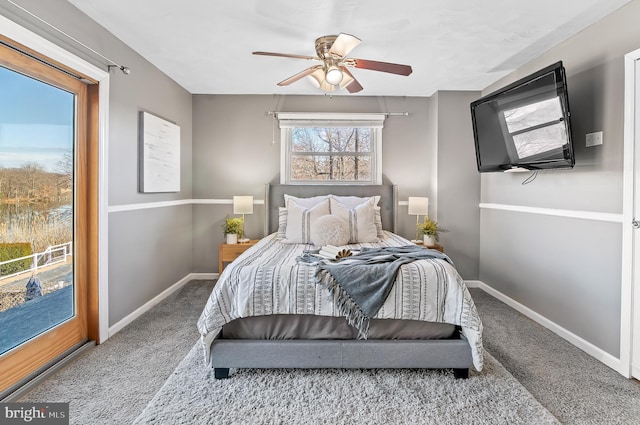 carpeted bedroom with access to exterior, baseboards, and a ceiling fan