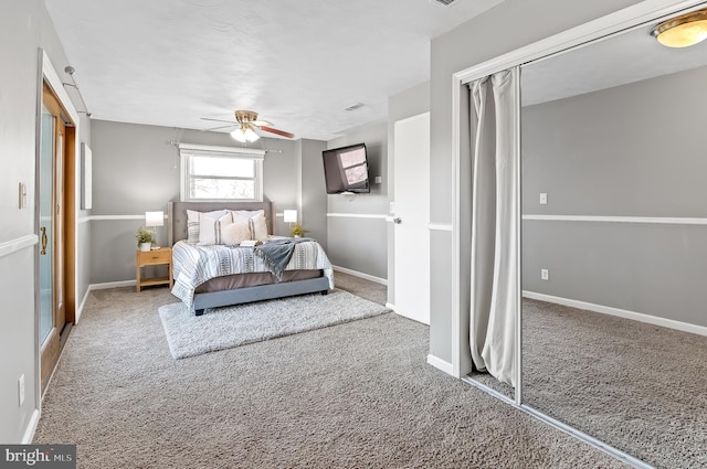 carpeted bedroom with a ceiling fan and baseboards