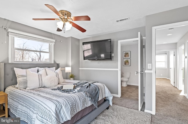 bedroom with baseboards, multiple windows, visible vents, and carpet flooring