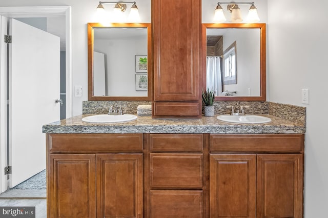 bathroom with a sink and double vanity