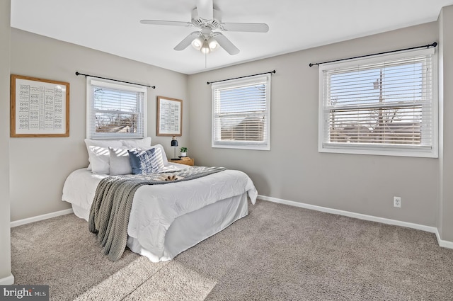 carpeted bedroom featuring a ceiling fan and baseboards