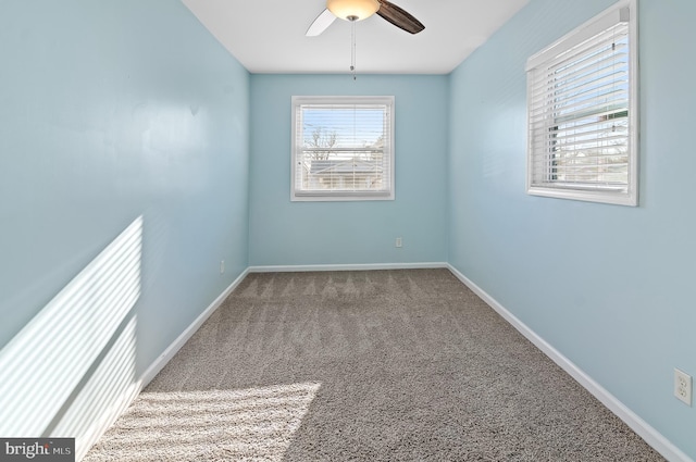 unfurnished room with carpet floors, baseboards, and a ceiling fan