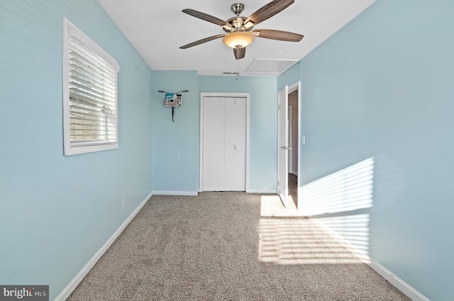 unfurnished bedroom with carpet flooring, visible vents, a ceiling fan, baseboards, and a closet