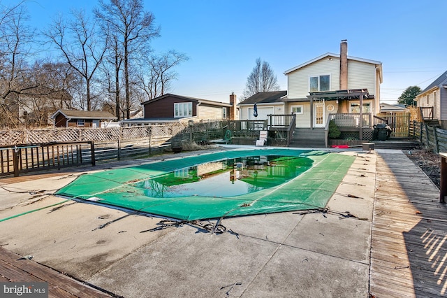 view of swimming pool featuring a fenced in pool, a patio area, fence, and a deck