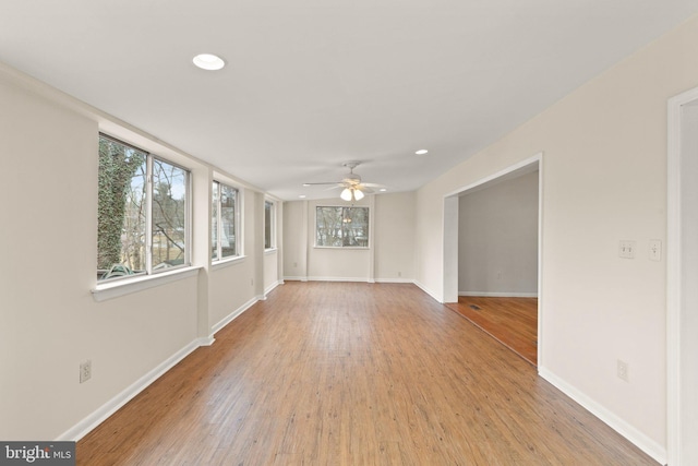 empty room featuring ceiling fan, recessed lighting, wood finished floors, and baseboards