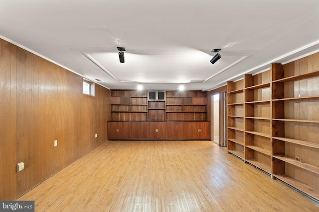 interior space with wood walls and light wood-style flooring