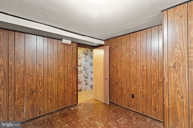 spare room featuring wooden walls