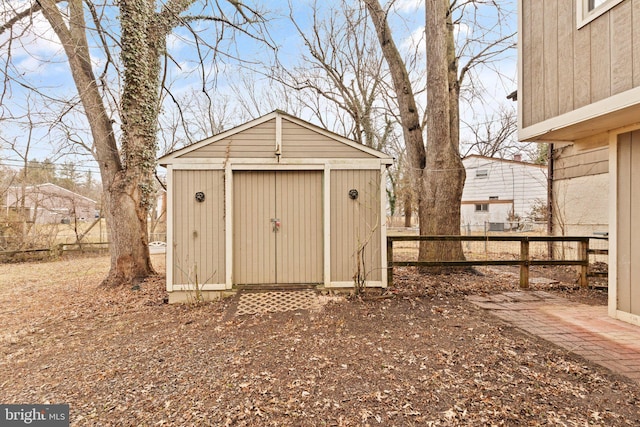 view of shed featuring fence