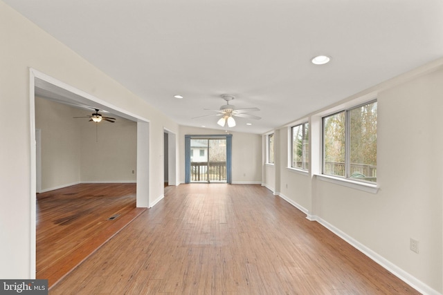 unfurnished living room featuring light wood-type flooring, baseboards, a ceiling fan, and recessed lighting