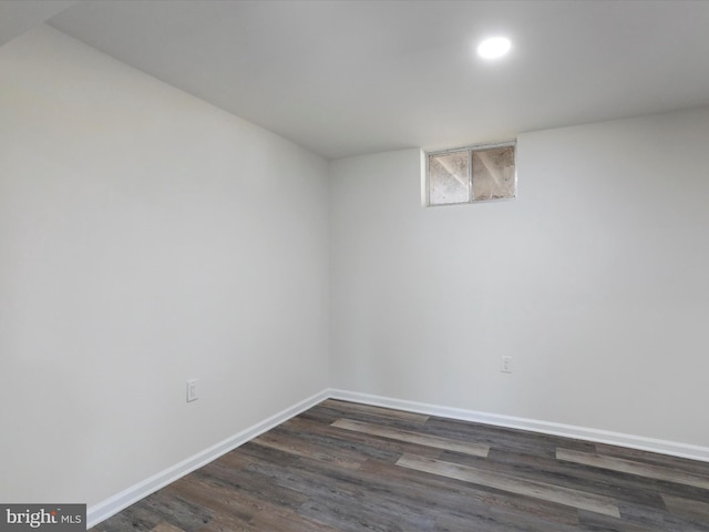 basement with dark wood-style flooring and baseboards