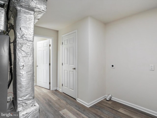 interior space with baseboards and wood finished floors