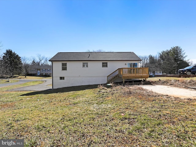 back of house with a yard and a deck