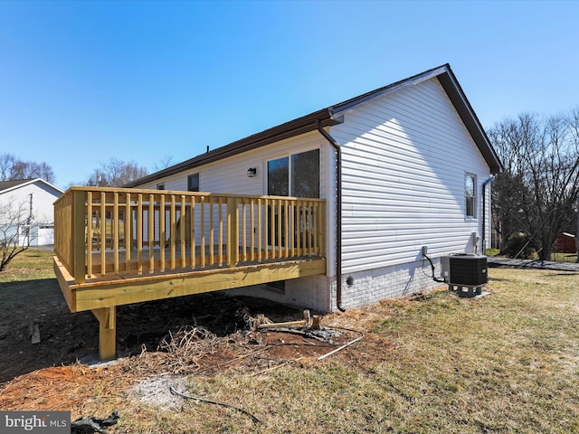 back of house featuring a yard, a deck, and central AC unit