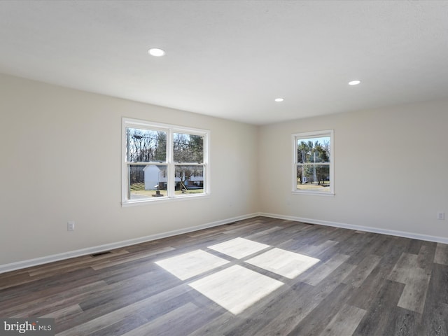 unfurnished room with dark wood-style floors, baseboards, and recessed lighting