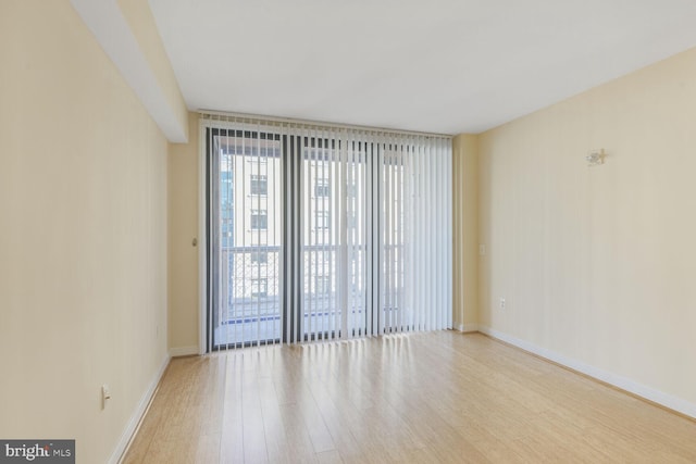 empty room featuring light wood-style floors and baseboards