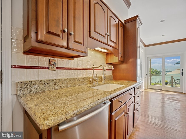 kitchen featuring ornamental molding, a sink, tasteful backsplash, light stone countertops, and dishwasher