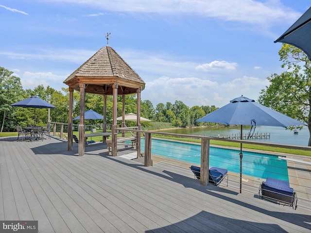 outdoor pool featuring a gazebo, outdoor dining space, and a wooden deck