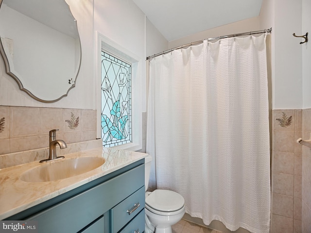 full bath with tile patterned flooring, toilet, vanity, a shower with curtain, and tile walls