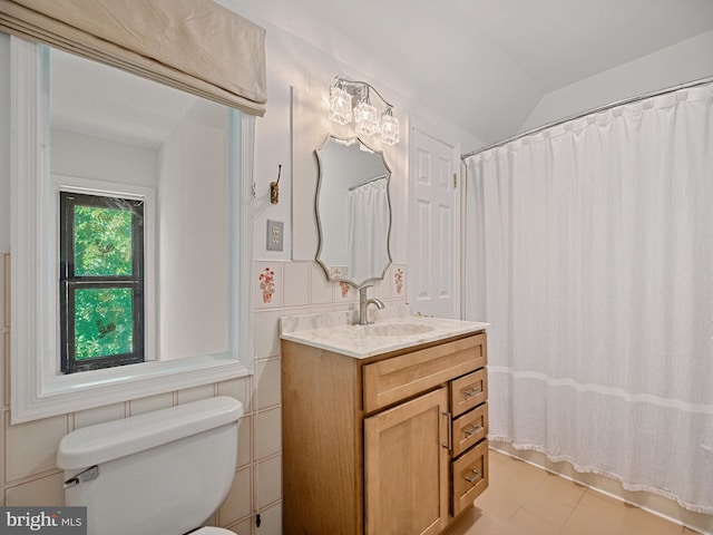 full bathroom featuring vanity, vaulted ceiling, curtained shower, tile walls, and toilet