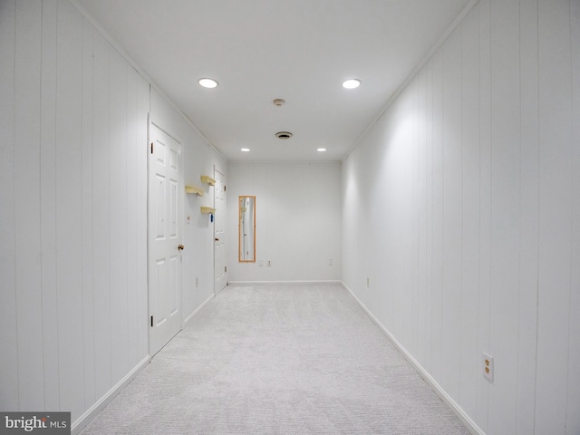 hallway with recessed lighting, light colored carpet, and baseboards