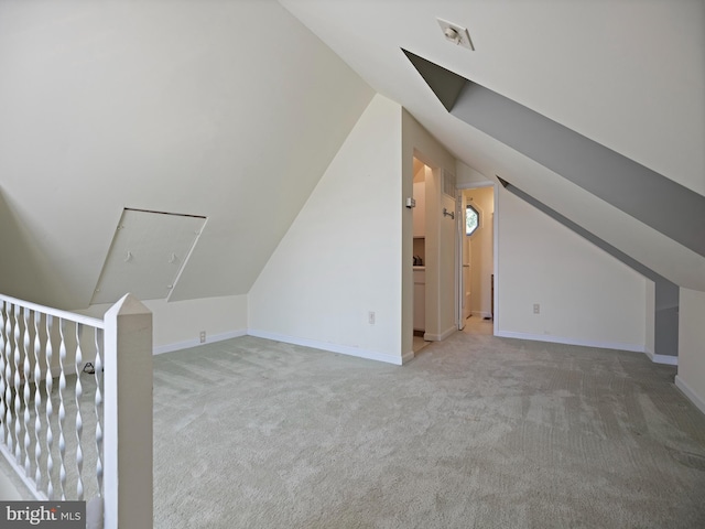 additional living space with lofted ceiling, carpet, and baseboards