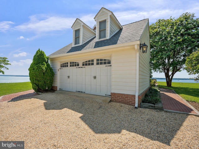 garage featuring a water view and driveway