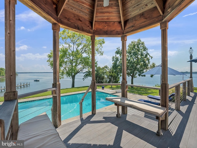 outdoor pool with a gazebo and a deck with water view