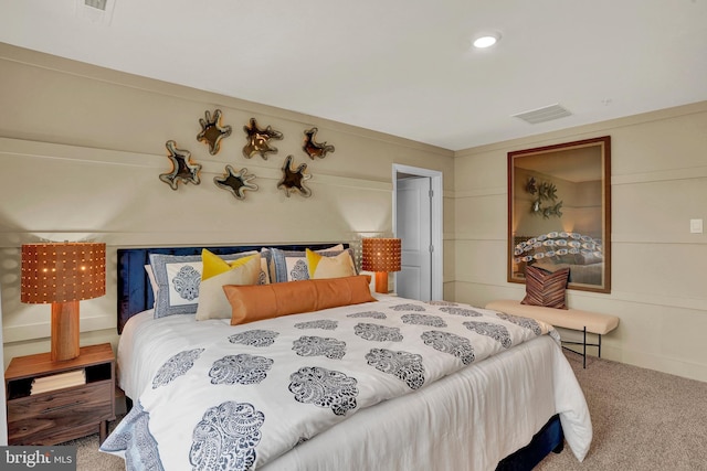 carpeted bedroom featuring visible vents