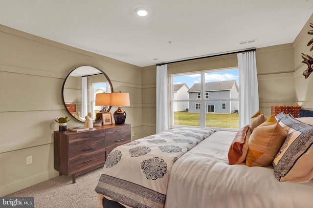 bedroom featuring light colored carpet, visible vents, and baseboards