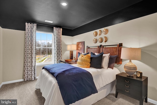 bedroom featuring light colored carpet and baseboards