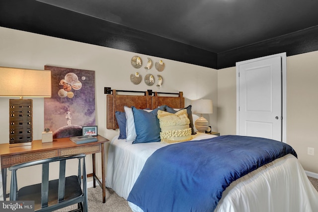 carpeted bedroom featuring baseboards