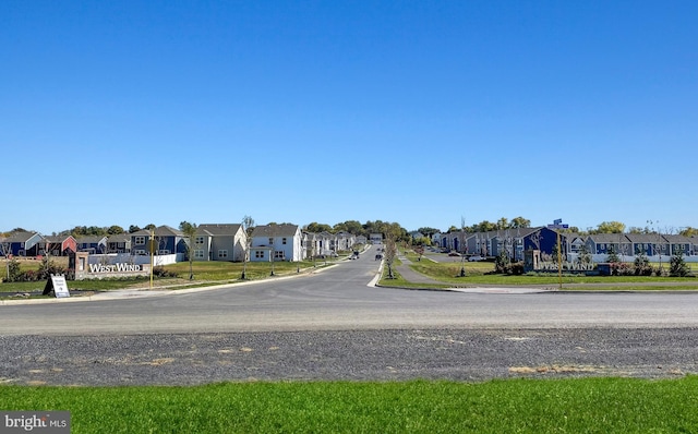 view of street featuring curbs and a residential view